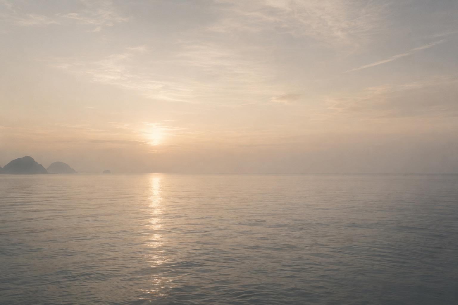 Calm open ocean meeting the sky at the horizon